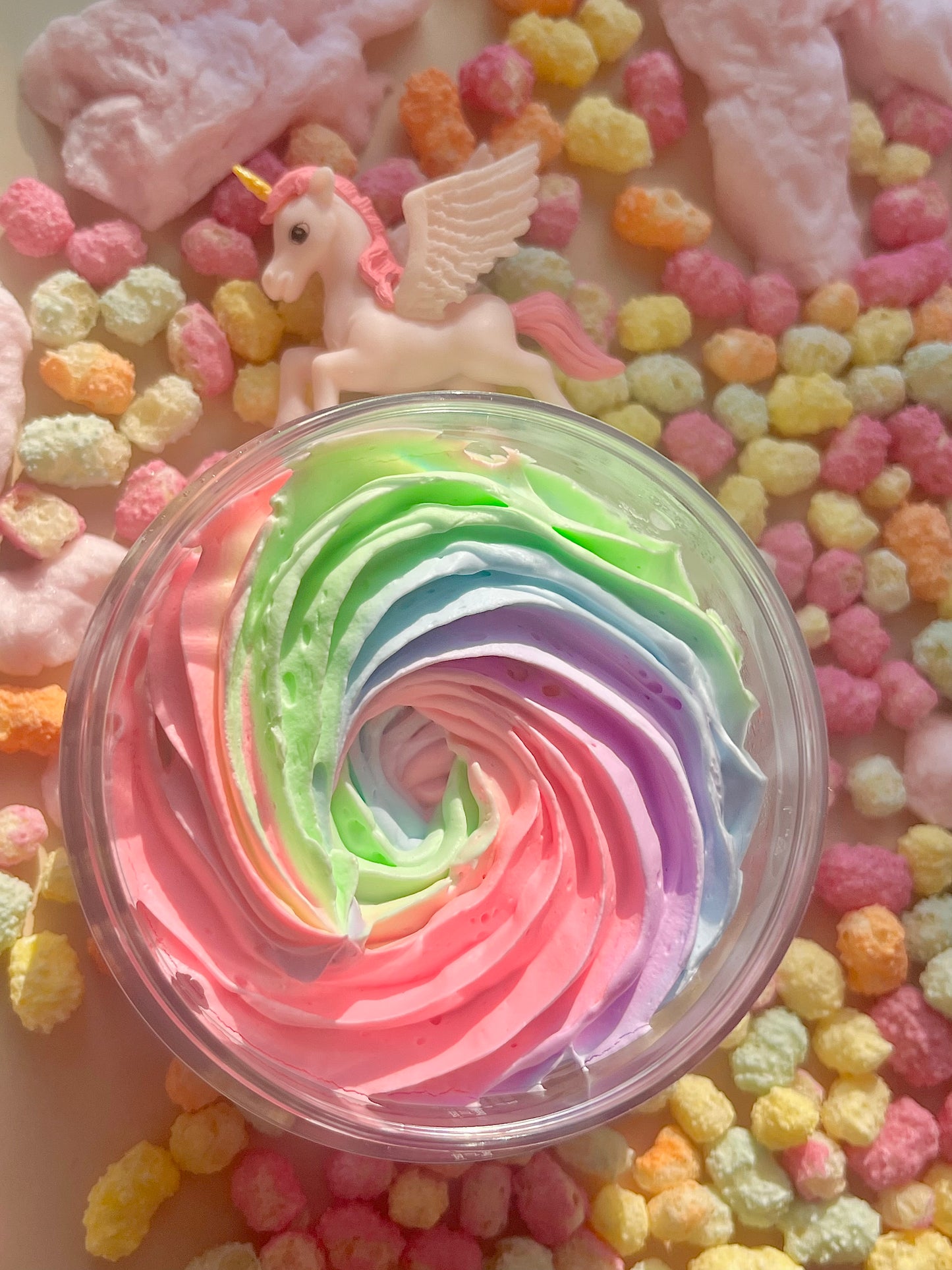 Colorful swirled rainbow unicorn whipped body butter in a container. Unicorn Glaze Whipped Body Butter - Unicorn/bubblegum/candy-floss, rainbow sweet fruity scented body moisturiser for dry skin and inflammatory skin conditions. Winter Skincare treatment, uk handmade vegan body butter