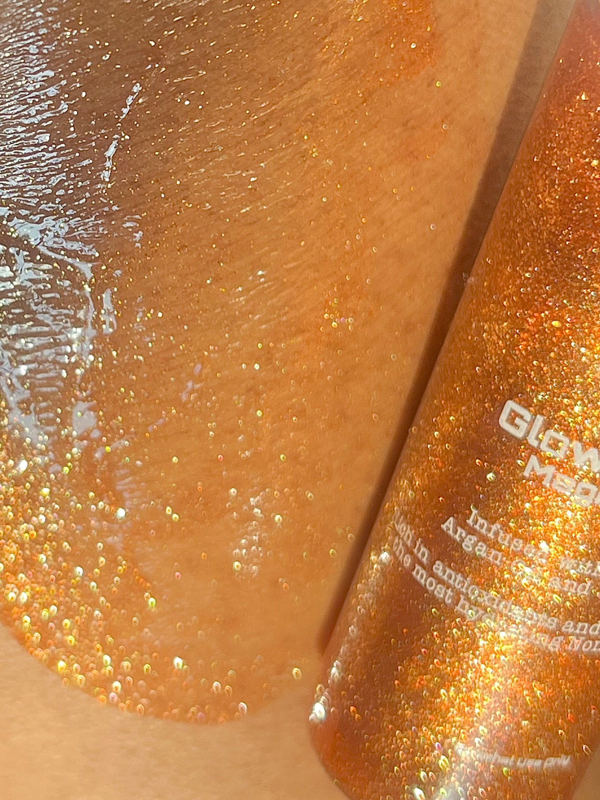 Bronze heat shimmer glitter body oil serum, Close-up of product applied to skin