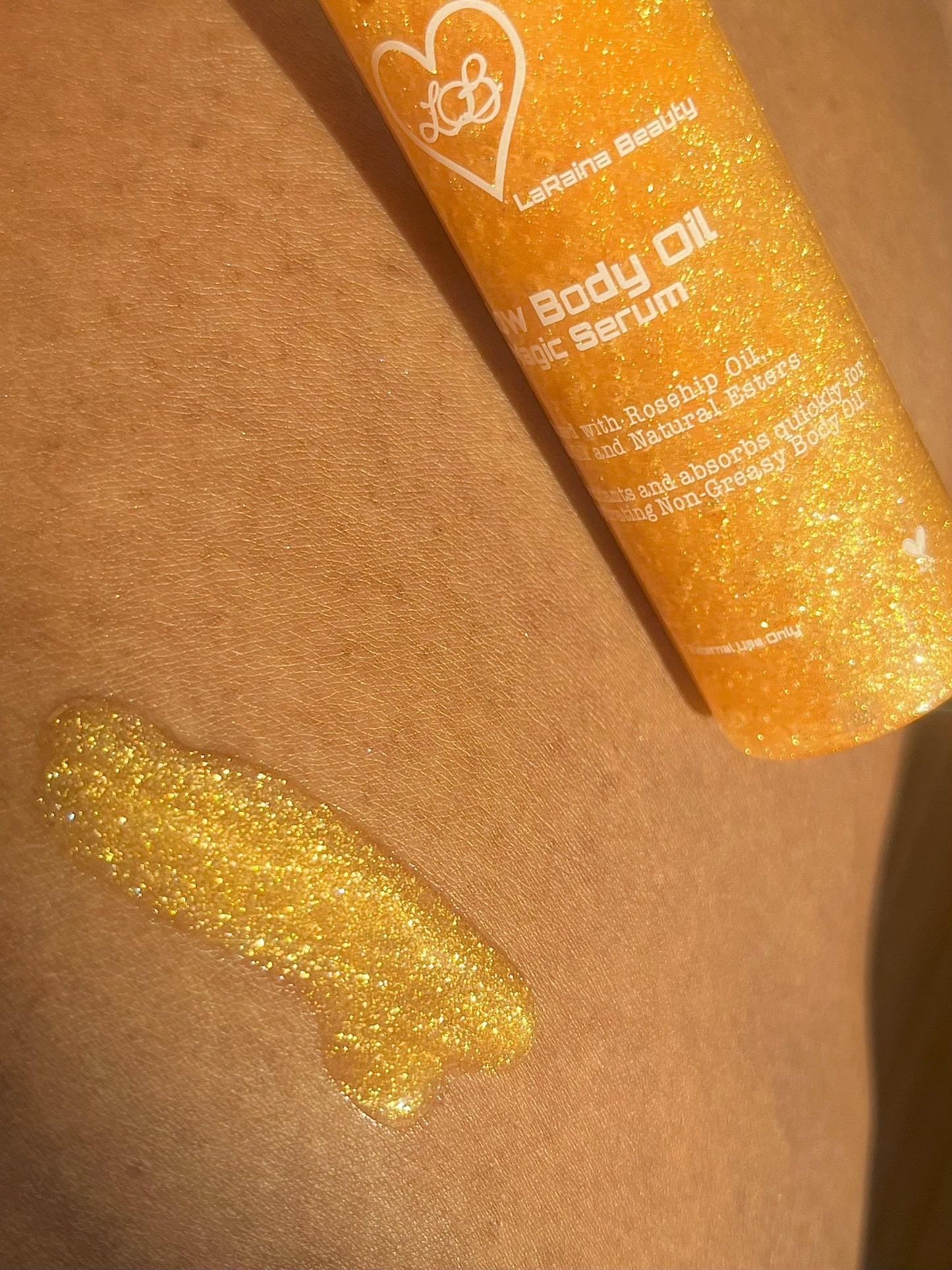Golden Shimmer Glitter Body oil or serum bottle with a droplet on skin