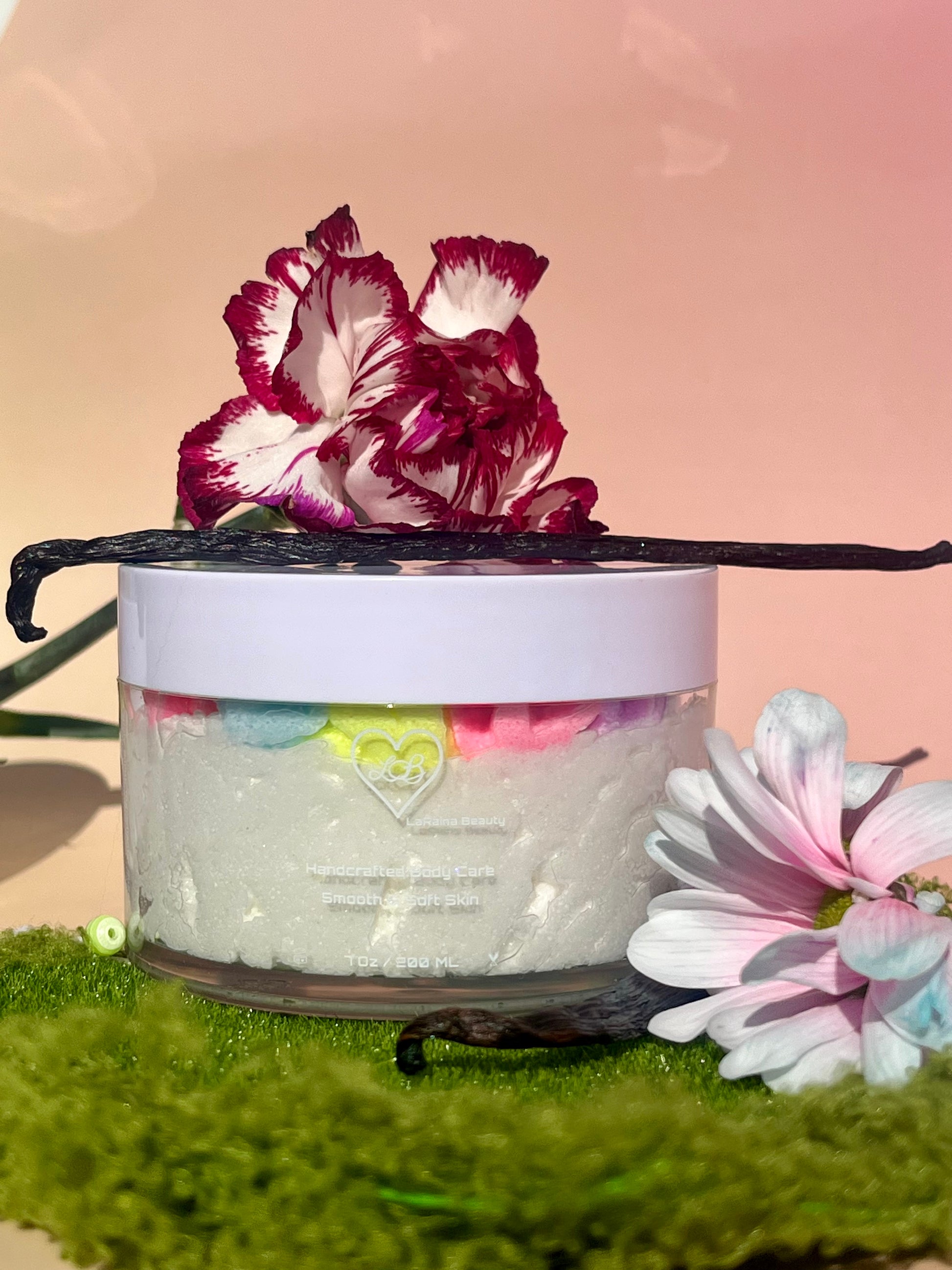 white shimmer base with multi colour flower top body scrub, floral fruity body exfoliant. A foaming/cleansing and exfoliating gentle body scrub to achieve smooth soft skin. UK handmade Vegan skincare that brings a fun luxurious experience to self care and shower routines. Scrub and get rid of patchy dry skin, clogged pores and ingrown hairs. The best body scrub you could ever ask for.