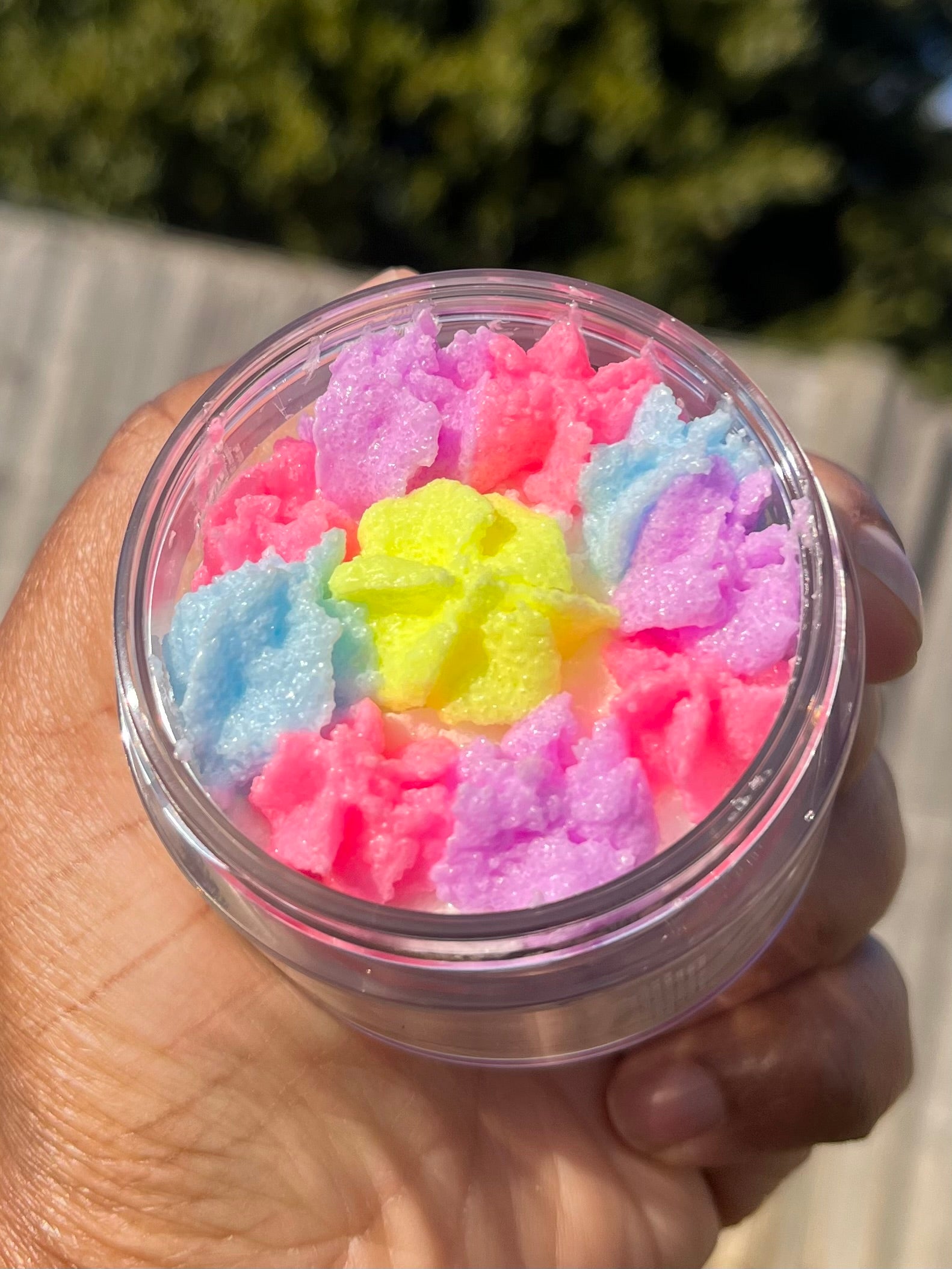 white shimmer base with multi colour flower top body scrub, floral fruity body exfoliant. A foaming/cleansing and exfoliating gentle body scrub to achieve smooth soft skin. UK handmade Vegan skincare that brings a fun luxurious experience to self care and shower routines. Scrub and get rid of patchy dry skin, clogged pores and ingrown hairs. The best body scrub you could ever ask for.
