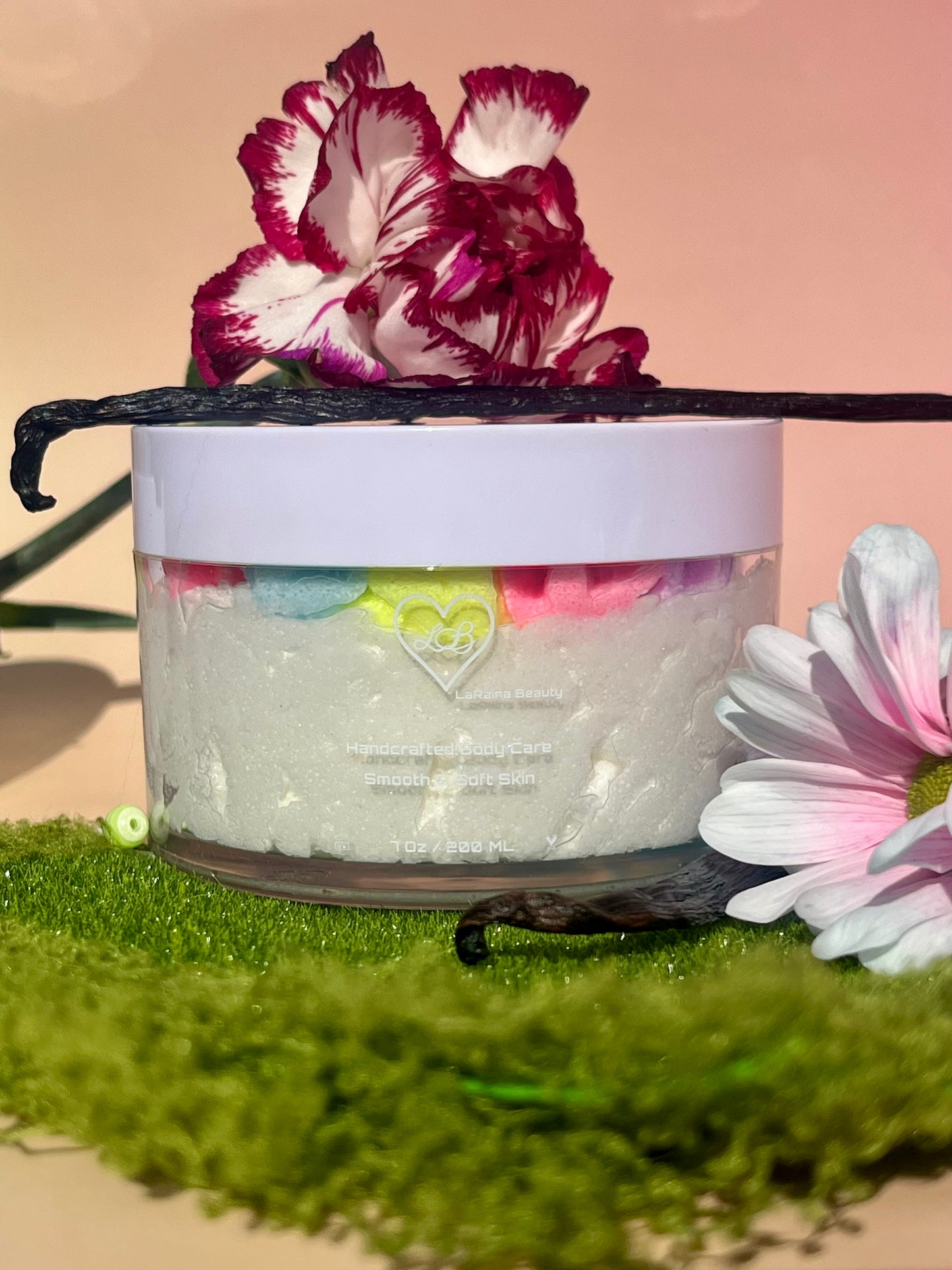 white shimmer base with multi colour flower top body scrub, floral fruity body exfoliant. A foaming/cleansing and exfoliating gentle body scrub to achieve smooth soft skin. UK handmade Vegan skincare that brings a fun luxurious experience to self care and shower routines. Scrub and get rid of patchy dry skin, clogged pores and ingrown hairs. The best body scrub you could ever ask for.