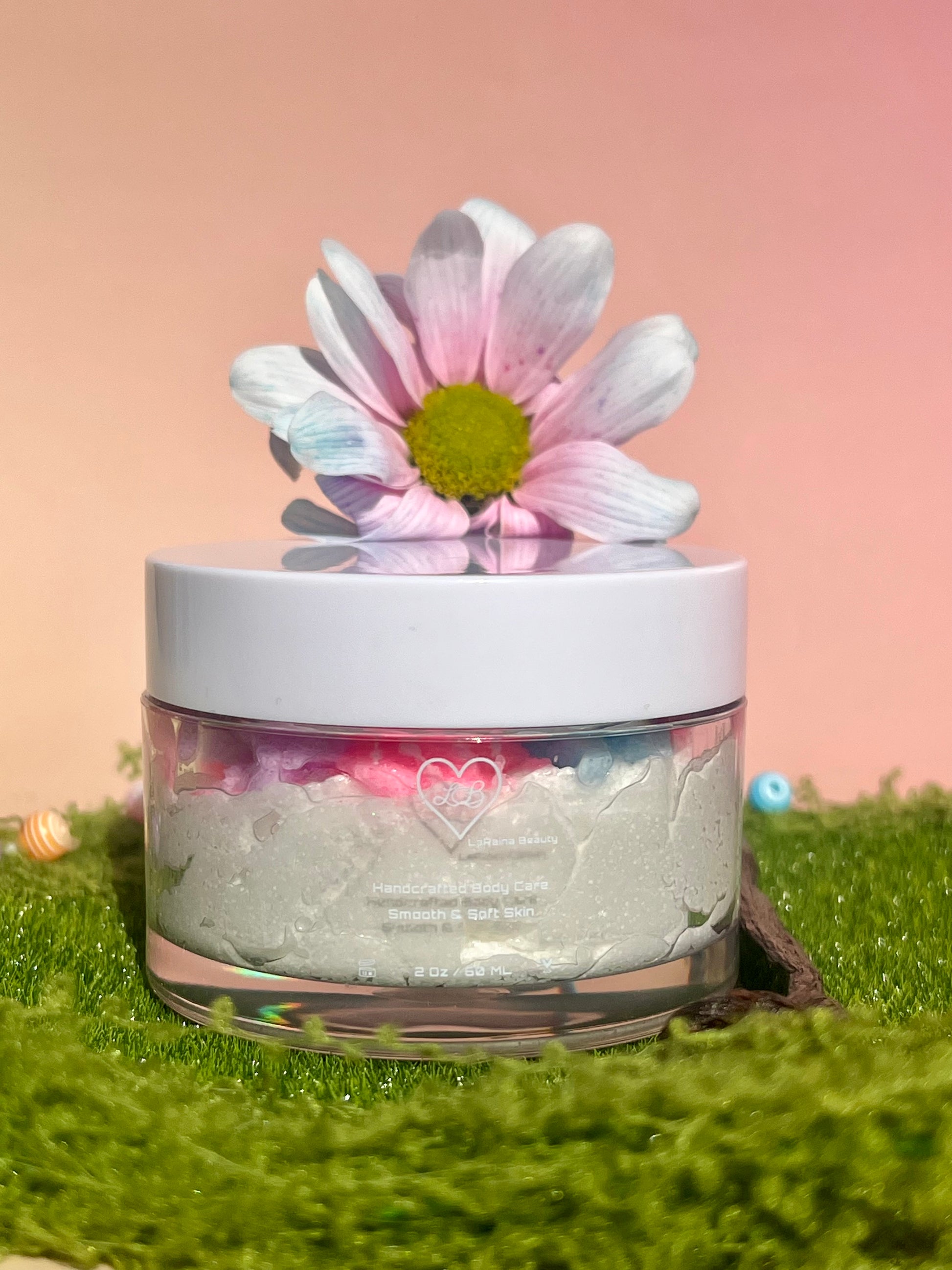 white shimmer base with multi colour flower top body scrub, floral fruity body exfoliant. A foaming/cleansing and exfoliating gentle body scrub to achieve smooth soft skin. UK handmade Vegan skincare that brings a fun luxurious experience to self care and shower routines. Scrub and get rid of patchy dry skin, clogged pores and ingrown hairs. The best body scrub you could ever ask for.